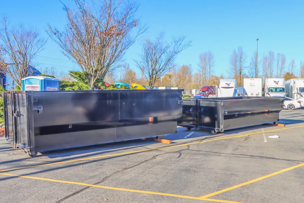 Professional dumpster rental service with roll-off container on residential driveway in Babylon